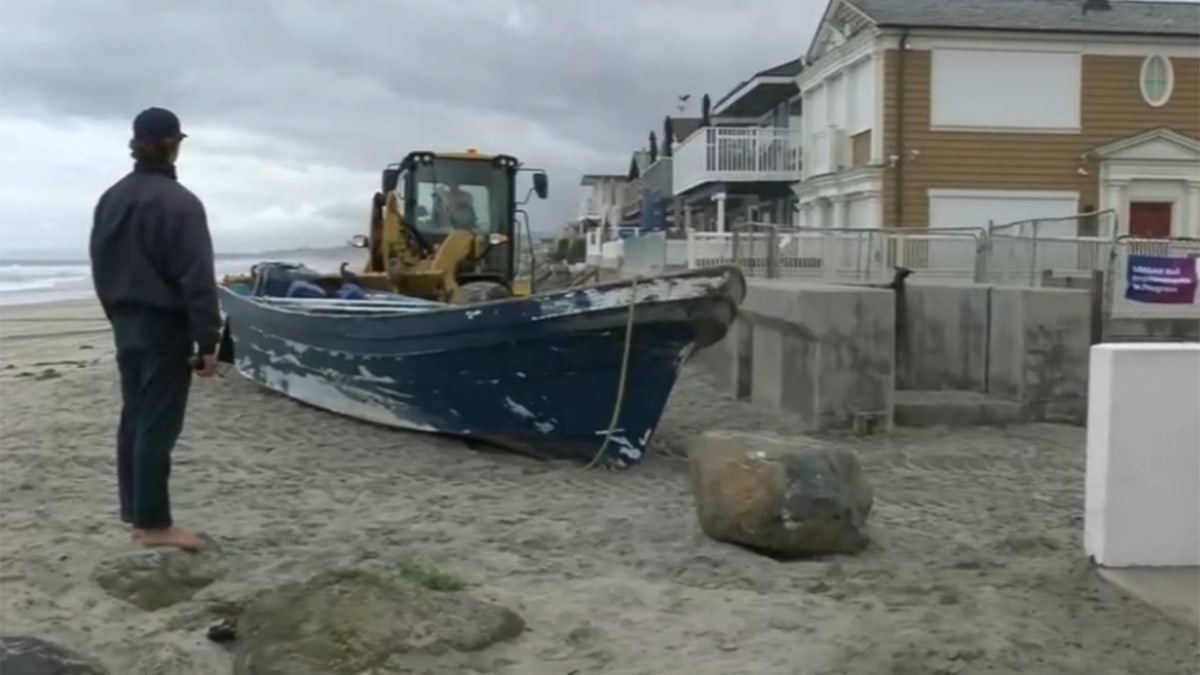 Boat washes onto beach into Del Mar, California