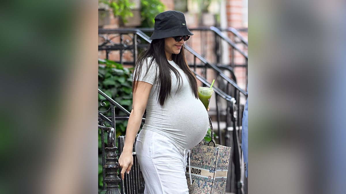 Cassie Ventura looking very pregnant wearing a tight shirt