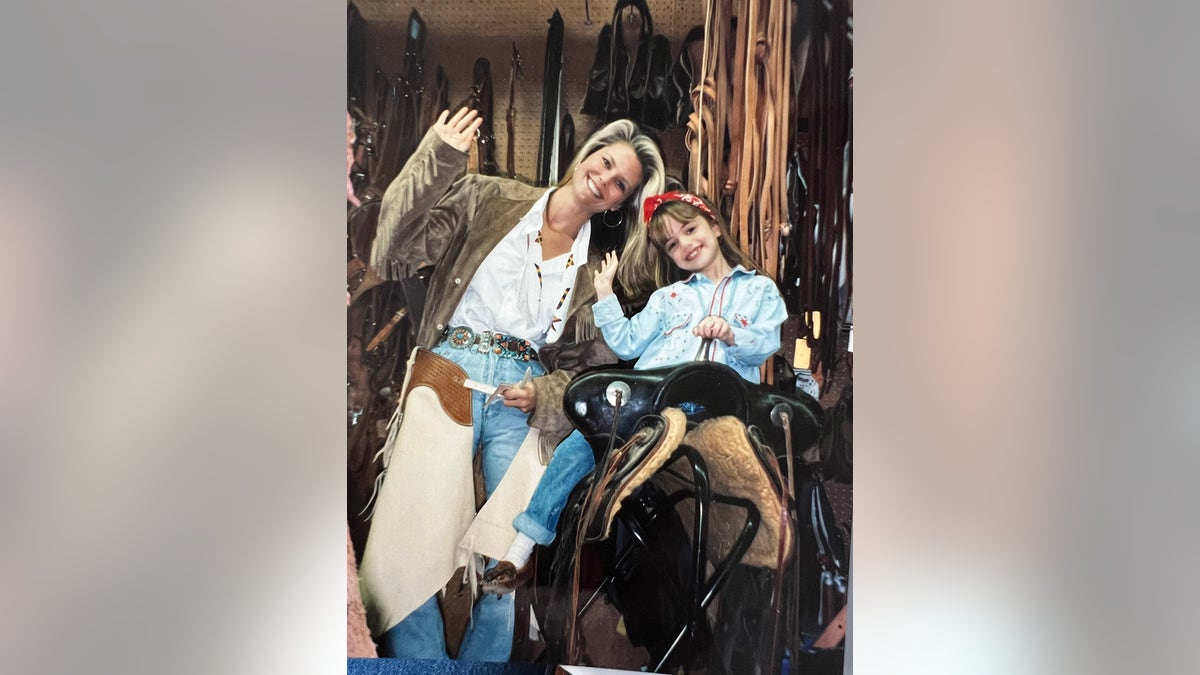 Christie Brinkley smiling in cowboy gear next to her daughter Alexa Ray Joel.