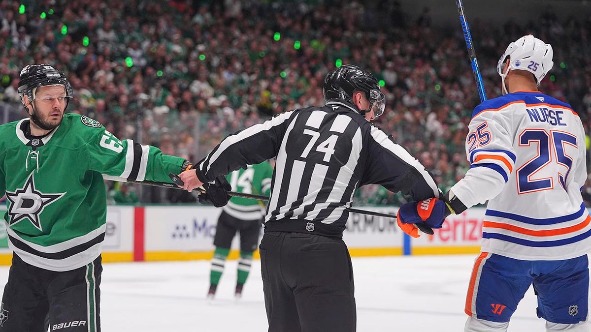 Stars right wing Evgenii Dadonov (63) and Edmonton Oilers defenseman Darnell Nurse tussle