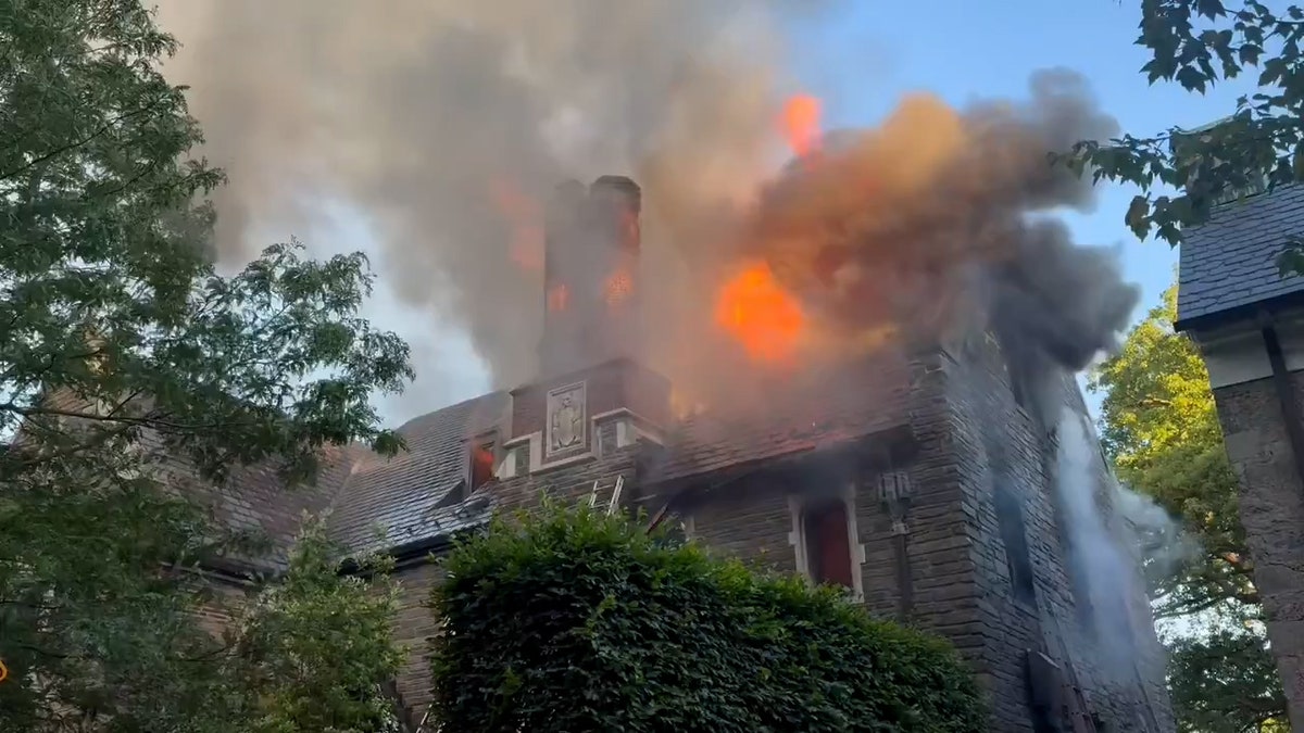roof on fire as smoke rises