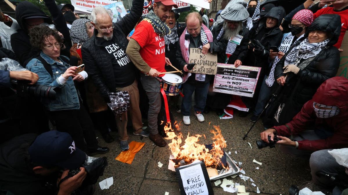 Demonstrators burn diplomas as Columbia University