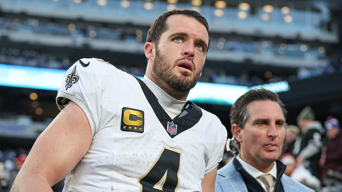 Derek Carr looks on