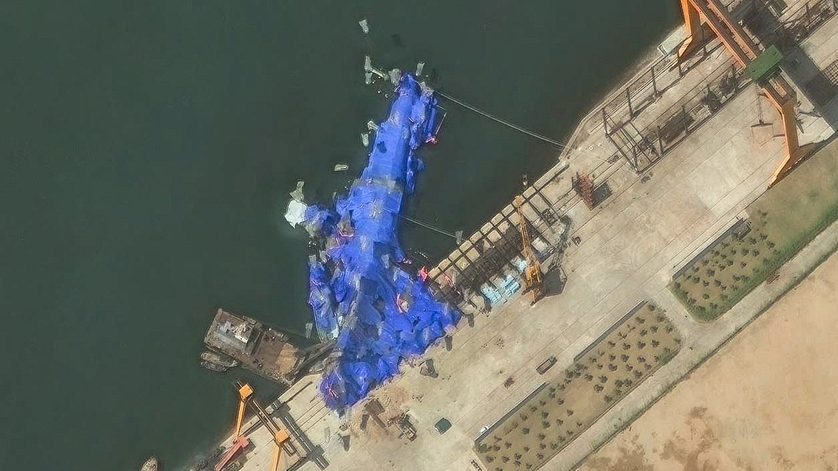 North Korea's naval warship under blue tarp