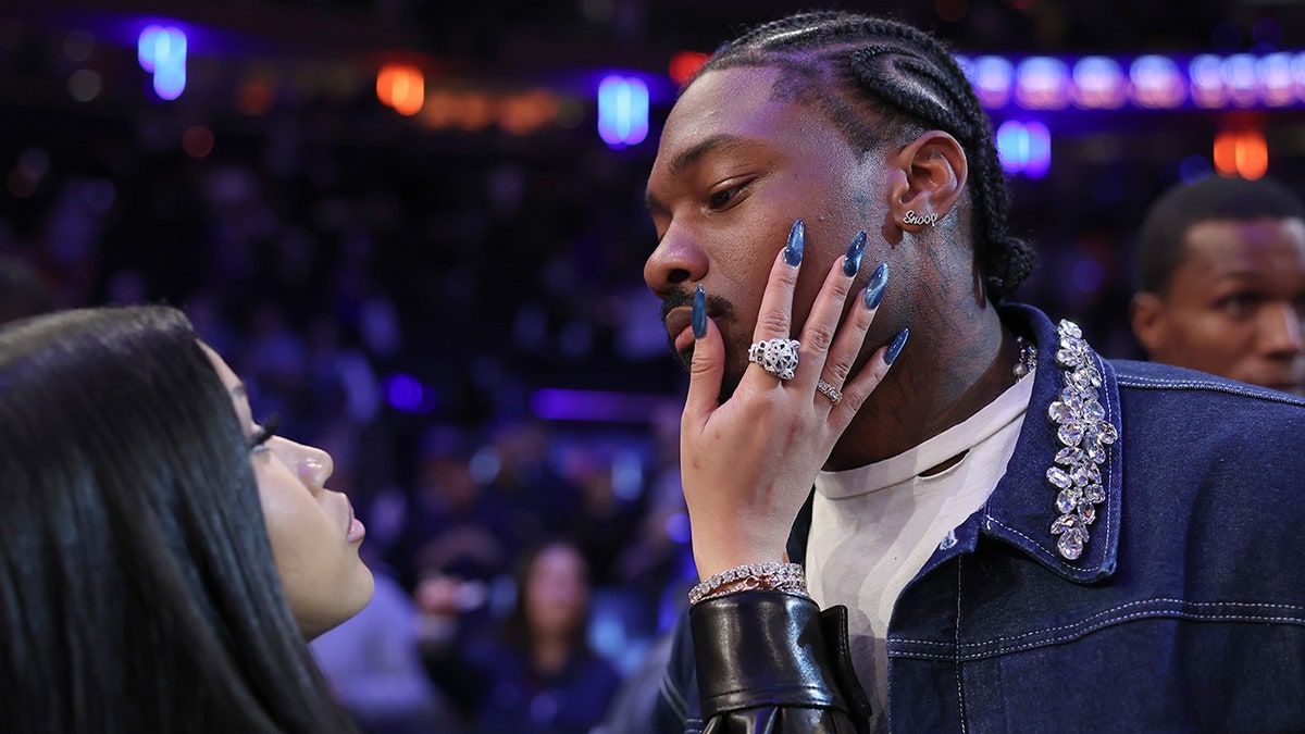 Stefon Diggs and Cardi B at an NBA game