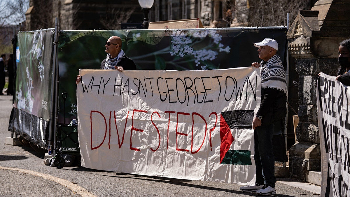 'Why hasn't Georgetown divested' sign on campus