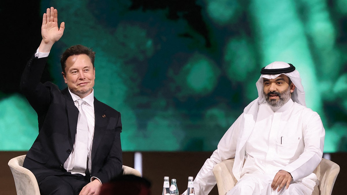 Elon Musk waves while attending conference during Saudi-US investment forum