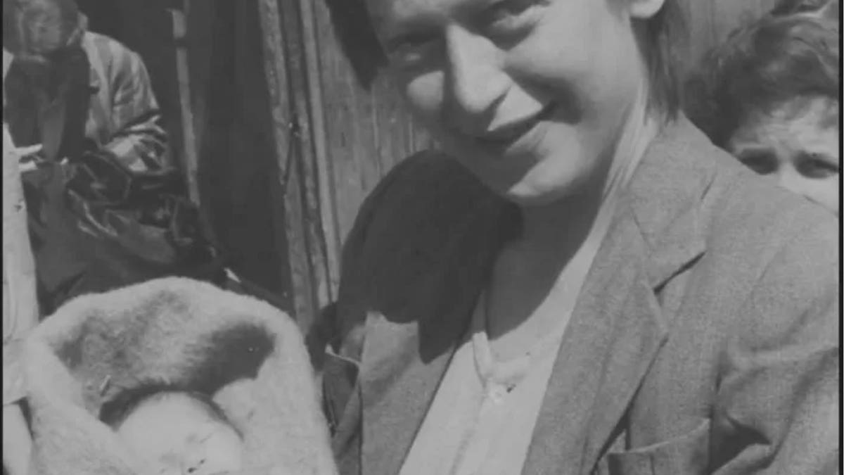 Eva Clarke as a baby held by her mother in Mauthausen concentration camp after liberation.