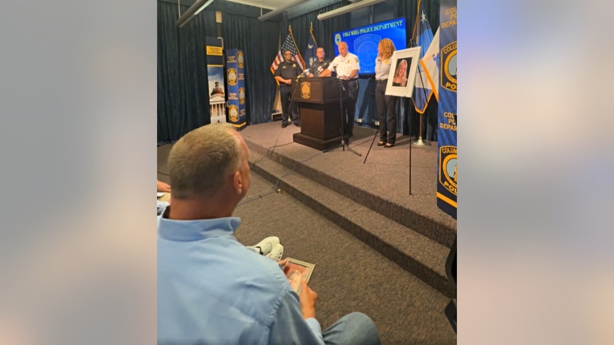 Stephen Federico holds a photograph of his girl during a May 5 property conference.