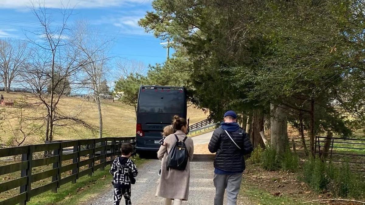 jessica biel, justin timberlake and their sons walking down a road with their back to the camera