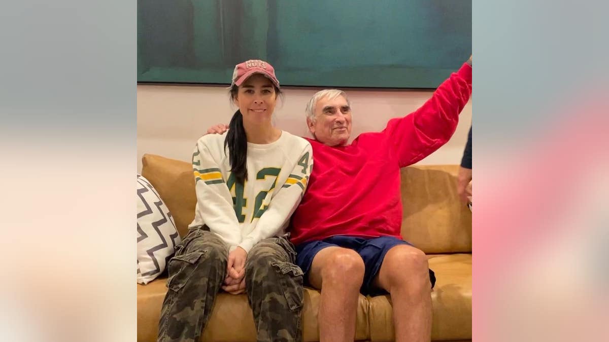 sarah silverman sitting on a couch with her father donald