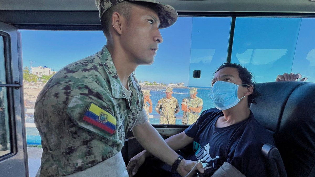 soldier checks the vitals of one of five shipwrecked fishermen
