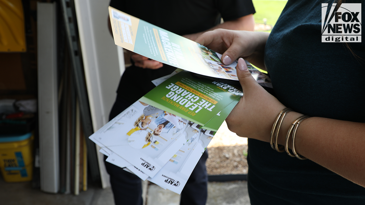 AFP passed out pamphlets to Mackenzie's constituents on Saturday about Trump's 2017 tax cuts.