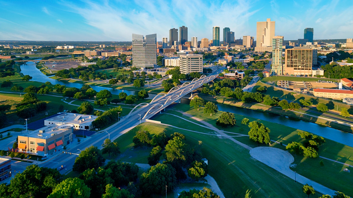 Aerial view of downtown Fort Worth, Texas, during the day with the Trinity River in the foreground.