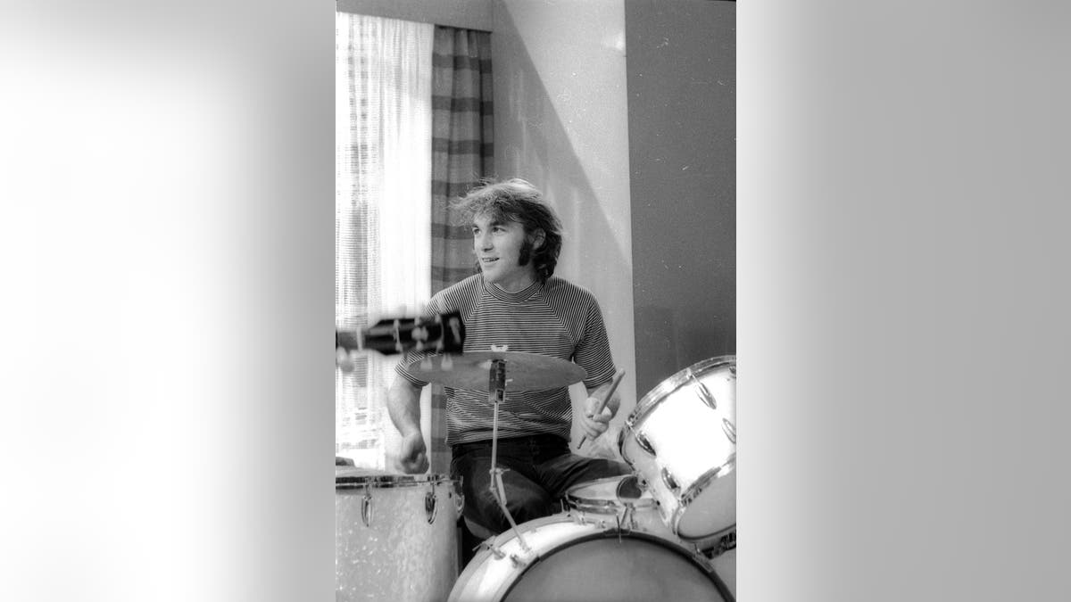 Dennis Wilson playing the drums.