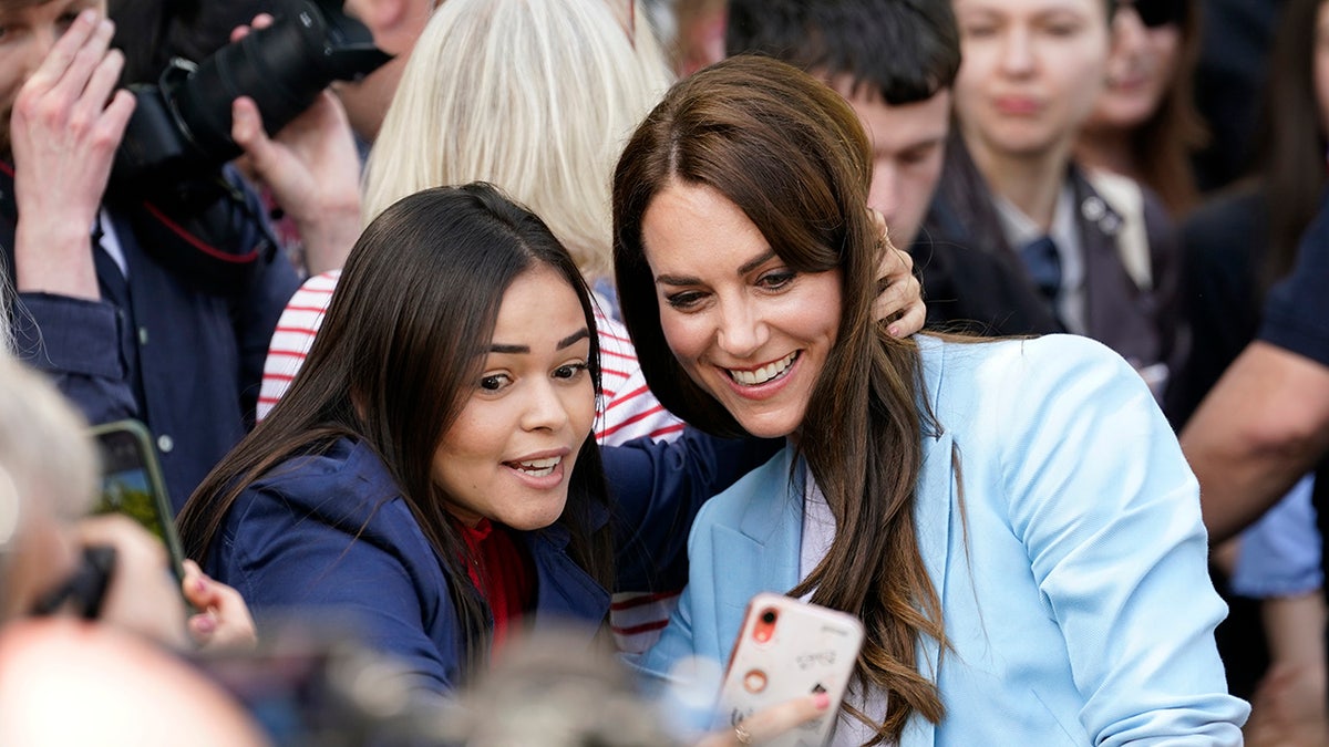 Kate Middleton smiling for a selfie.