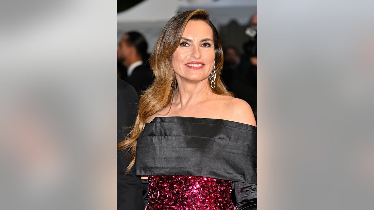 Mariska Hargitay wearing a black and hot pink sparkling strapless gown.