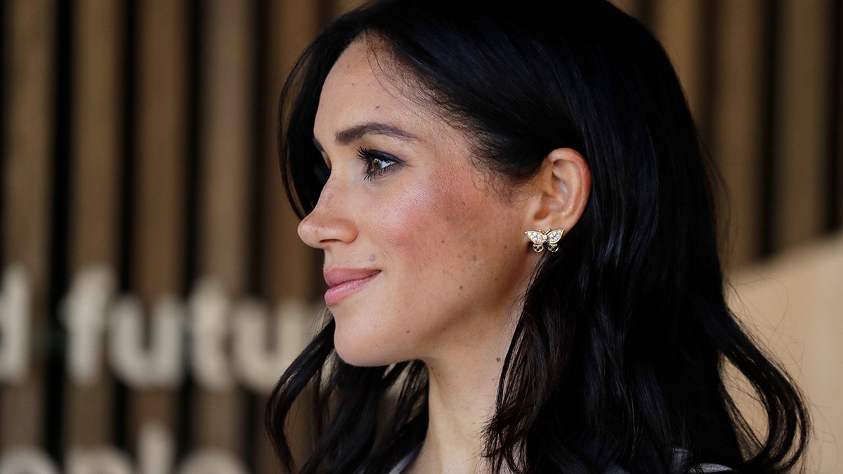 A close-up of Meghan Markle with the word "future" behind her.