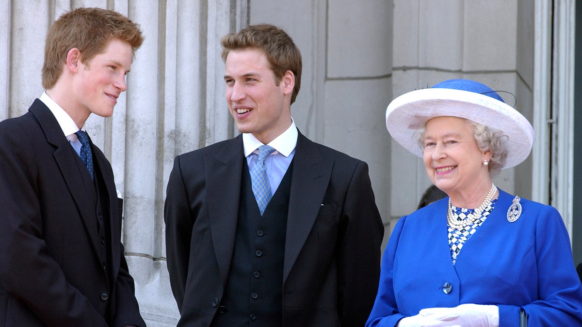 Prince Harry and Prince William smiling at each other as Queen Elizabeth looks on.