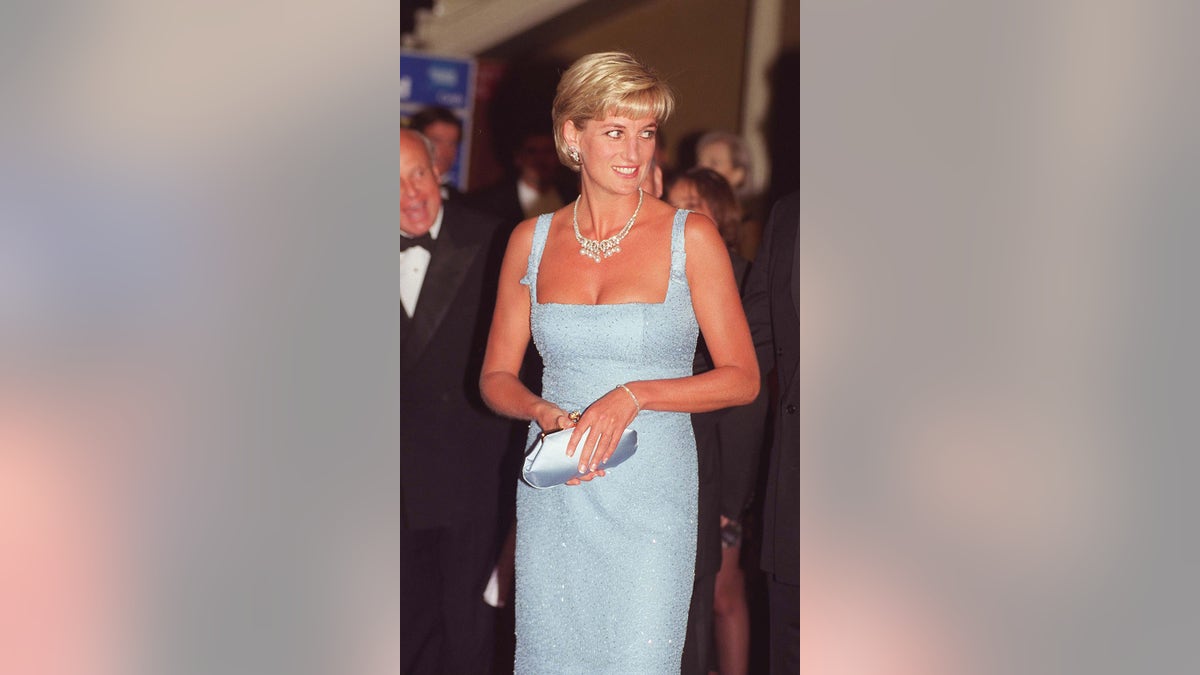 Princess Diana wearing a strappy light blue dress with a diamond necklace.