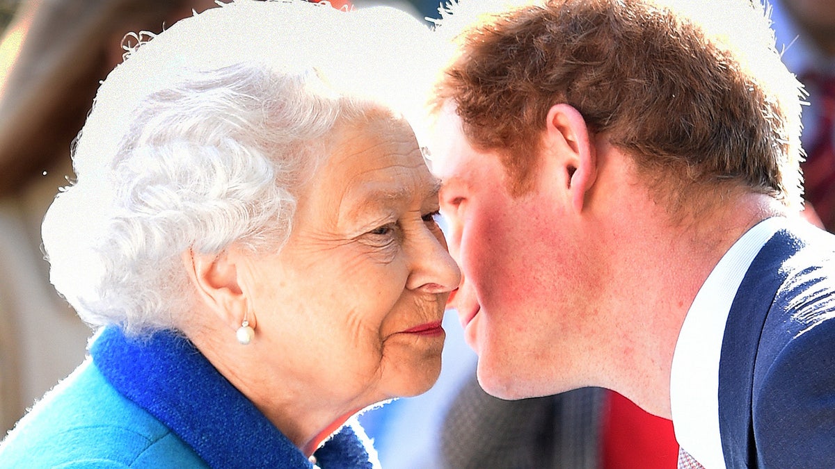 Prince Harry giving Queen Elizabeth a kiss on the cheek.