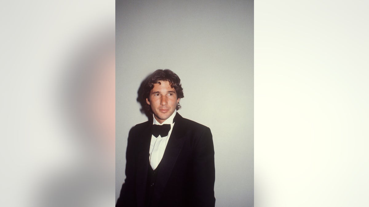 Richard Gere in a tux looking away.