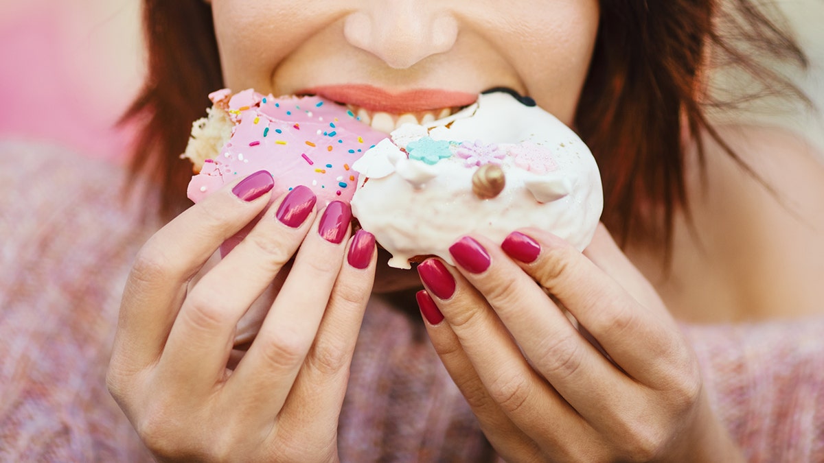 Woman eating donuts and sweets