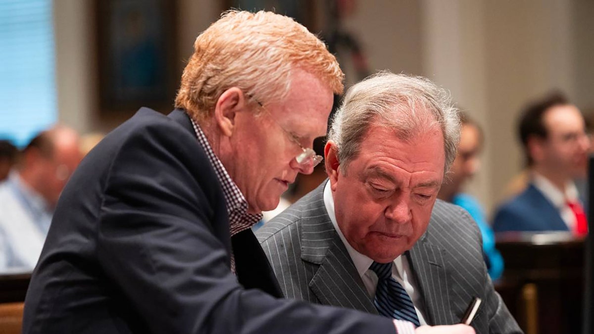 Alex Murdaugh and Dick Harpootlian sit together during Murdaugh's 2023 murder trial