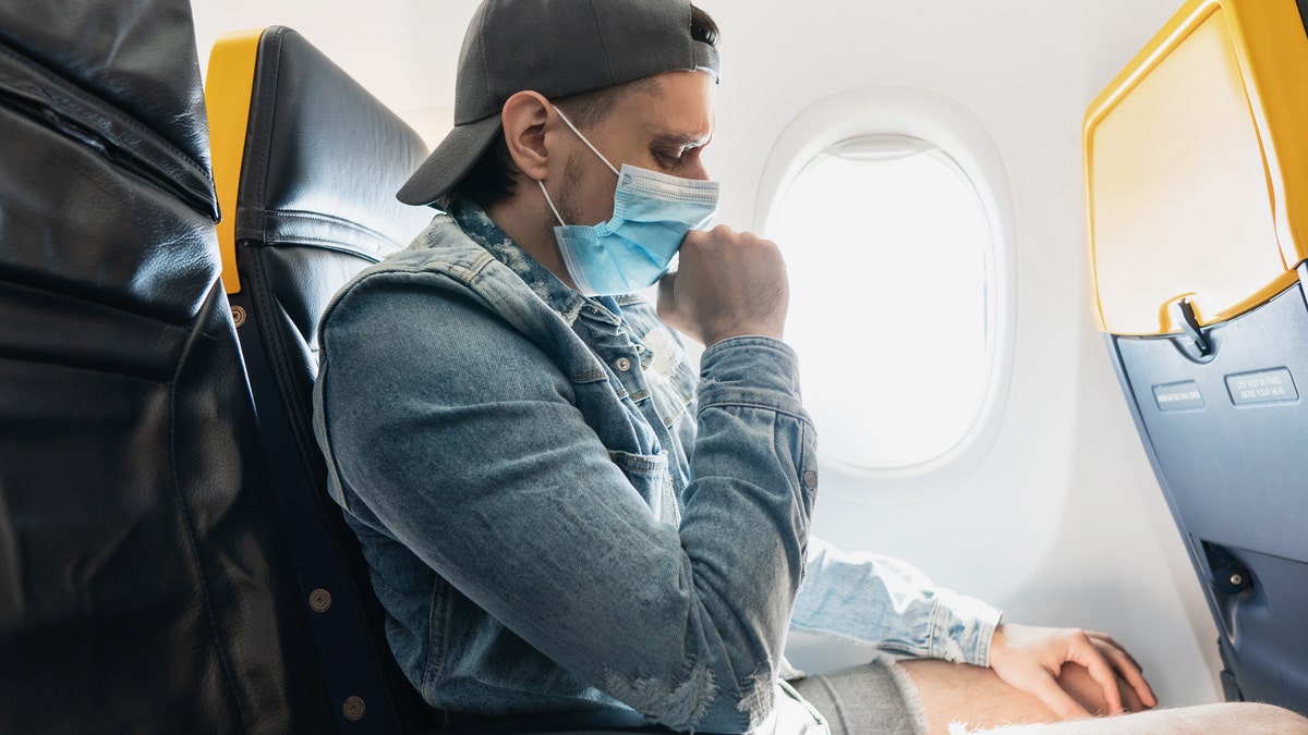 Man wearing prevention mask during a flight inside an airplane