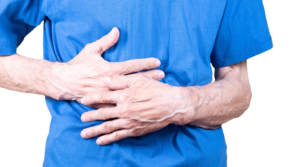 Man clutching at his liver