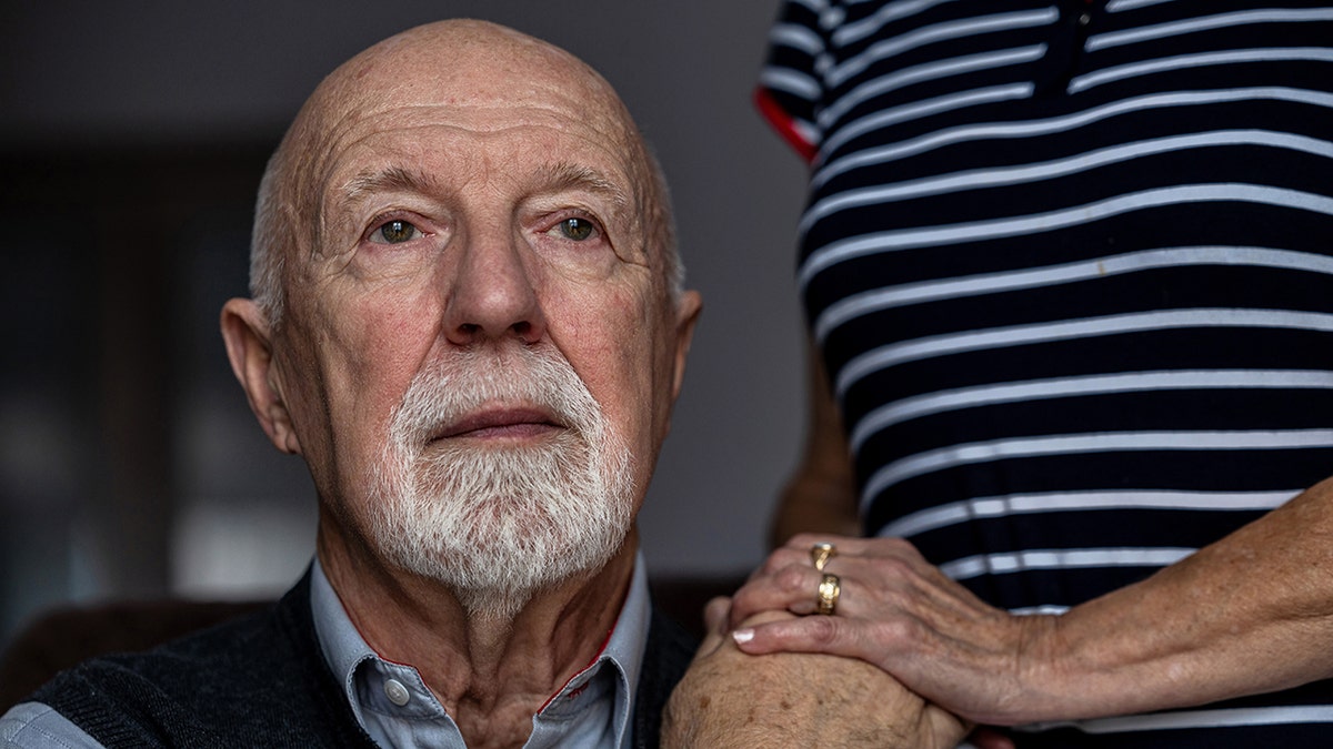 Portrait of a senior man with his caregiver in the background
