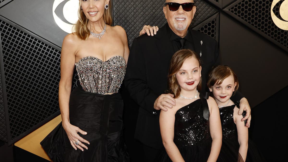 alexis joel and billy joel with their daughters at the grammys