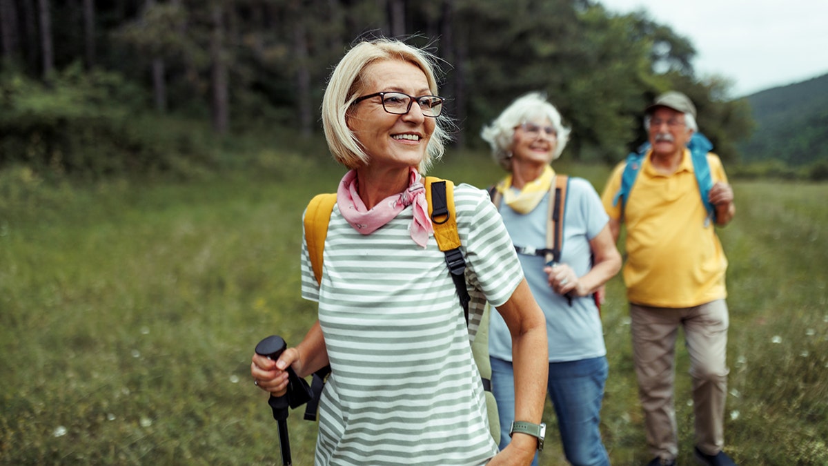 senior woman hiking with friends