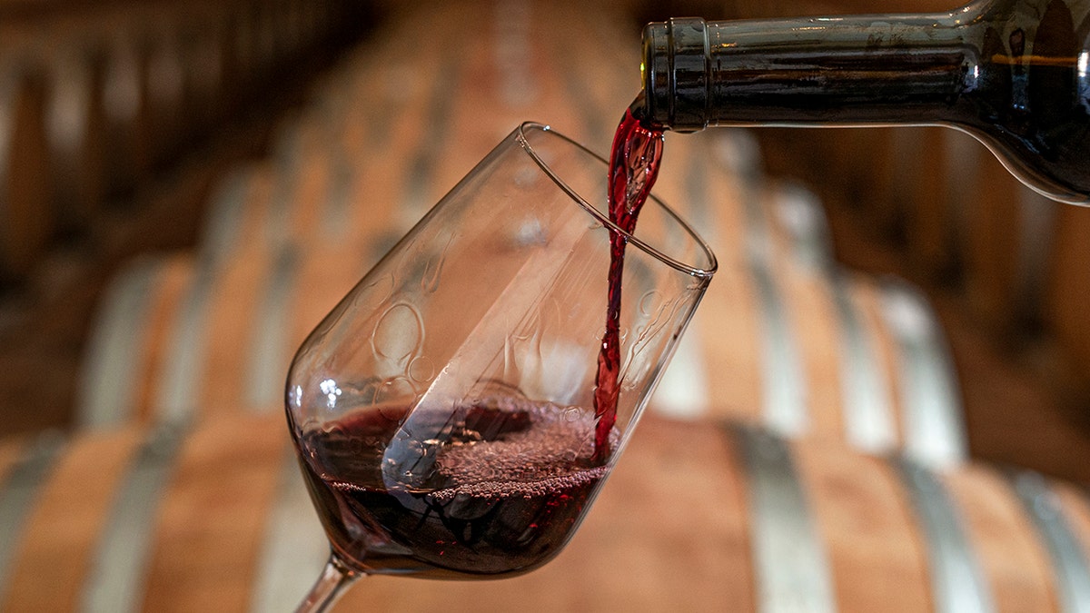 Strike red wine to a glass