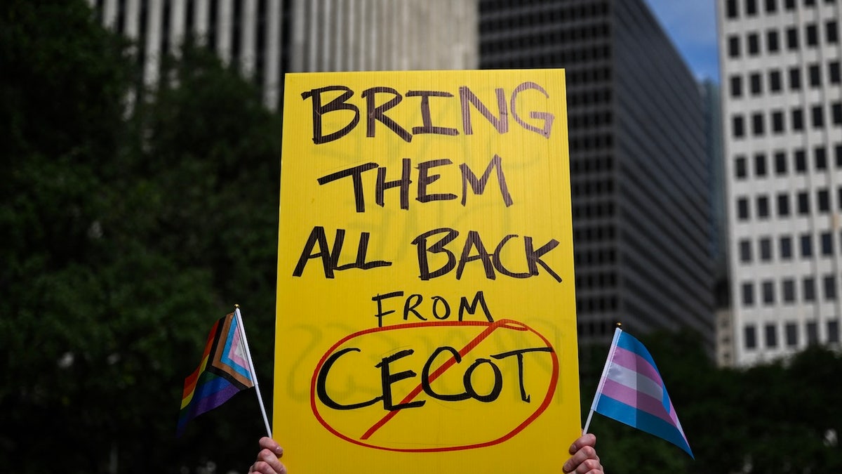 A protest sign demands the U.S. government return immigrants deported to El Salvador's CECOT prison