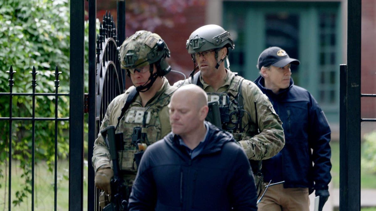 FBI agents leave the Albanian Park apartment building