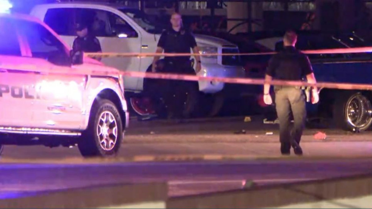 police walking near evidence markers in the street