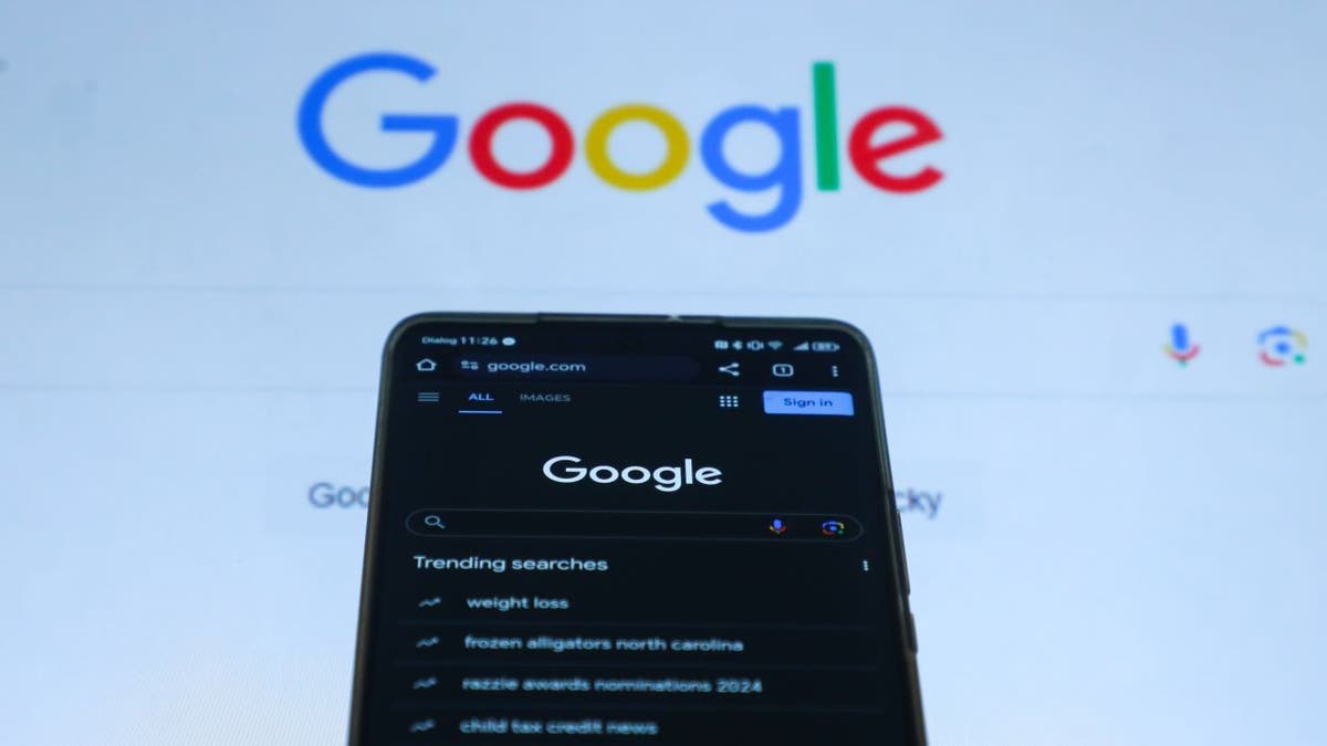 Google search display is seen on a mobile phone screen and computer. Photo via Getty Images