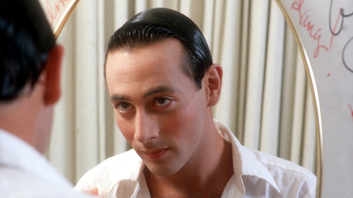 Paul Reubens looking at himself in the mirror.