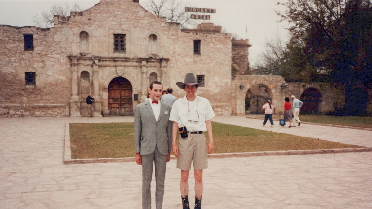 Paul Reubens in character standing next to T