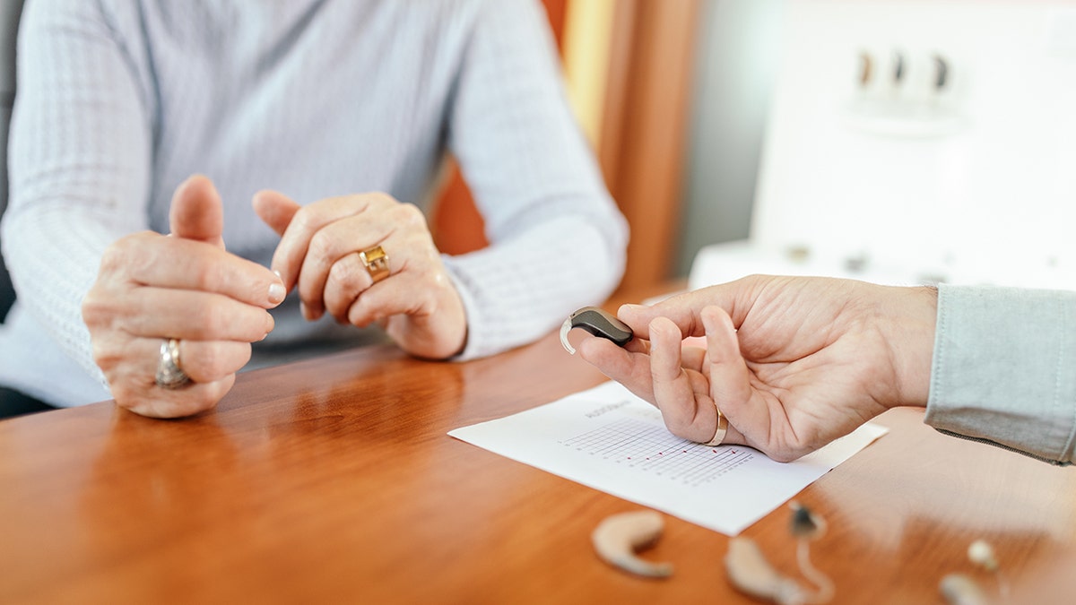 Senior pistillate choosing proceeding assistance instrumentality successful specialized aesculapian clinic. Doctor showing antithetic kinds of devices. Medical trial results carton is connected the table successful beforehand of her. A survey shows that repairing proceeding nonaccomplishment tin amended elder loneliness