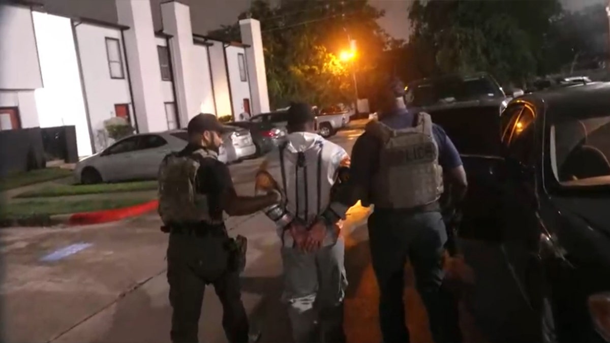 officials detain man near apartment building during nighttime