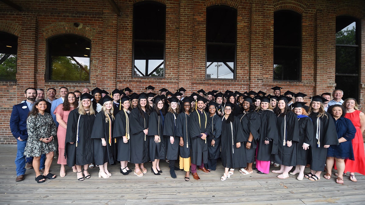 Independent Chick-Fil-A operators and the graduates of their team pose for a photograph at the University of Point.