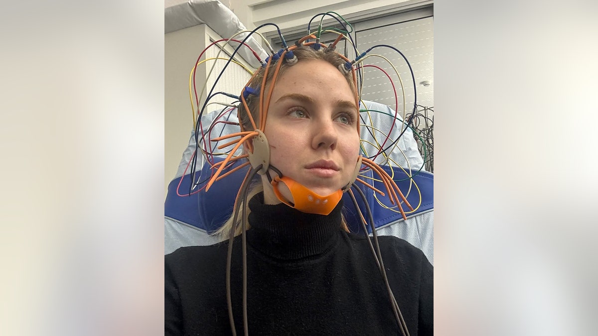 Princess Maria Carolina wearing a black sweater with wires all over her head.