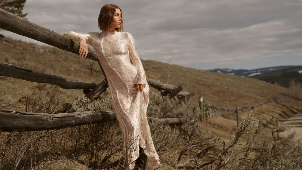 jessica biel leaning on a fence in montana