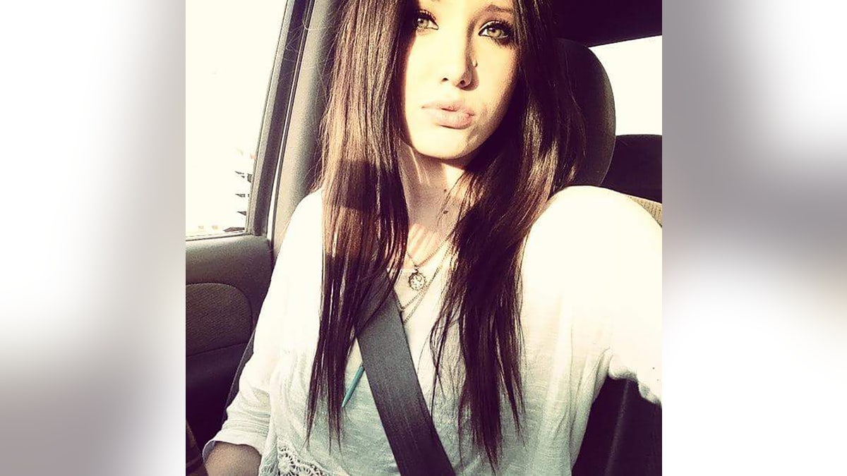 Baylee Despot giving a kissing selfie from wrong her car.