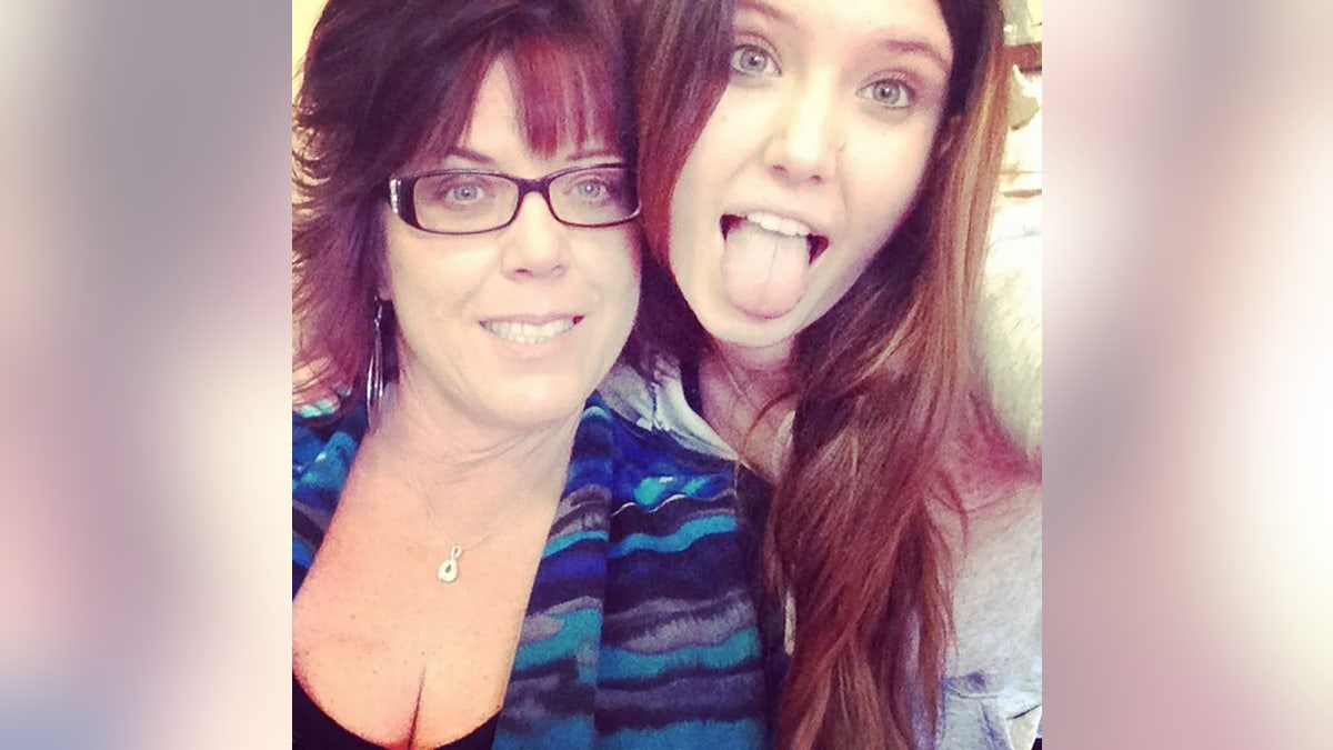 Jane Parrent posing pinch her girl Baylee Despot who is sticking retired her tongue.