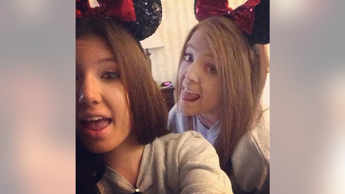 Baylee Despot taking a selfie pinch different young female wearing Mickey Mouse ears