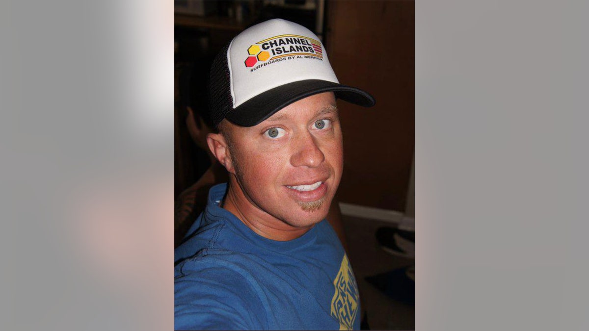 A close-up of James Kulstad wearing a bluish garment pinch a chapeau and taking a selfie.
