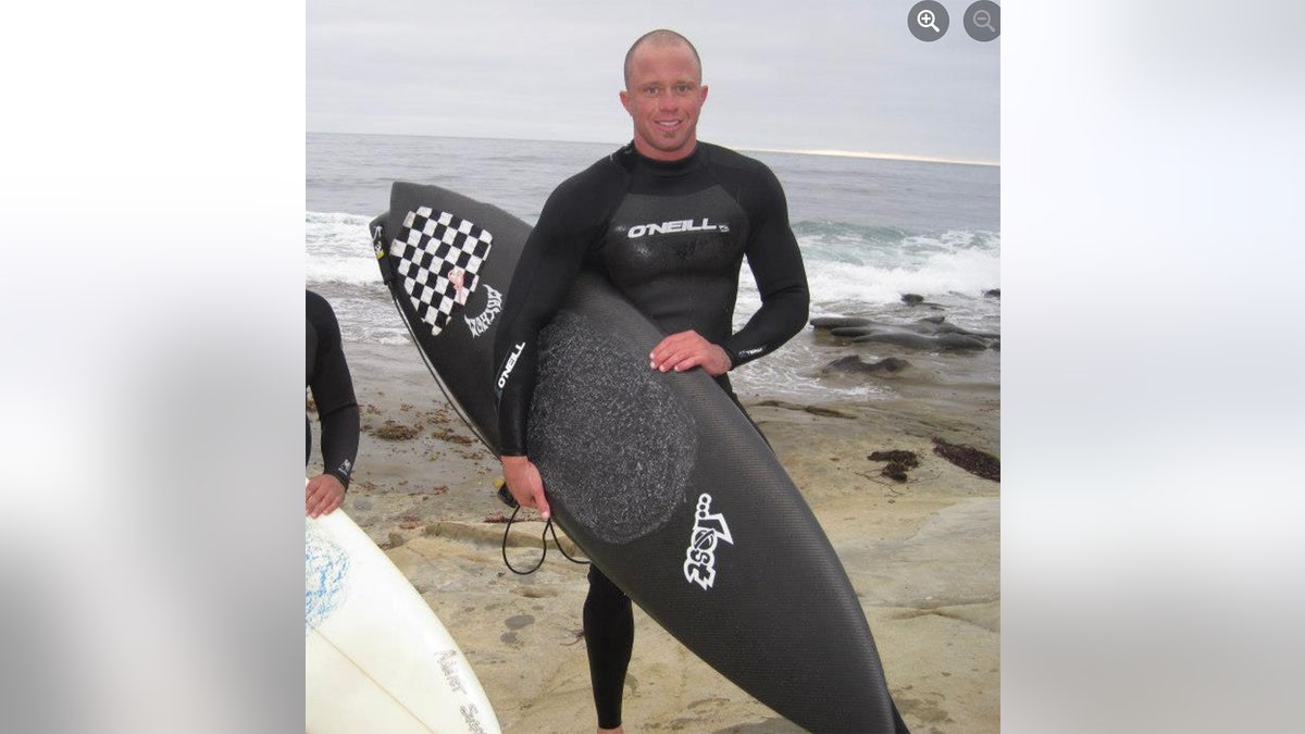 James Kulstad clasp surfboard astatine beach